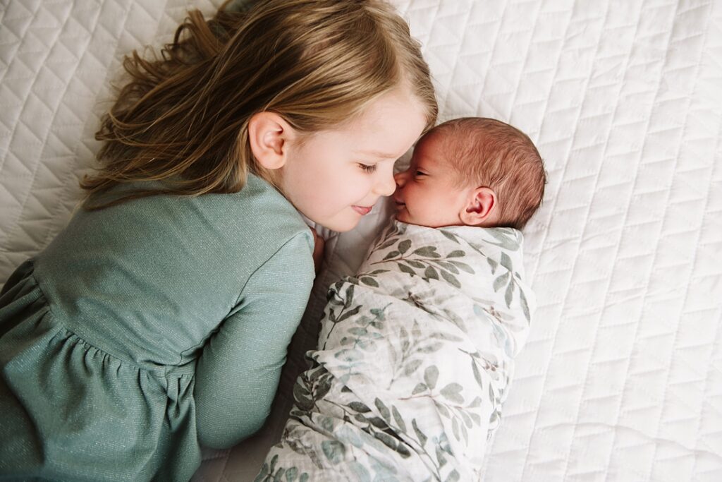 newborn baby with sister during photo shoot