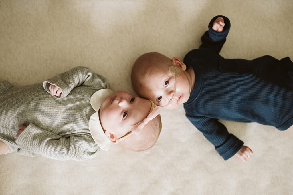 newborn twins laying in crib