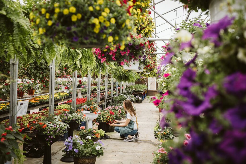 Personal branding portrait of a health coach shopping for plants in a greenhouse