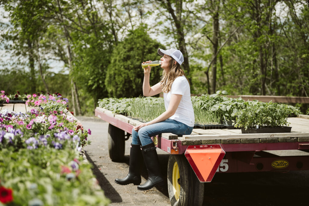 Personal branding portrait of a health coach drinking fresh juice at a farm