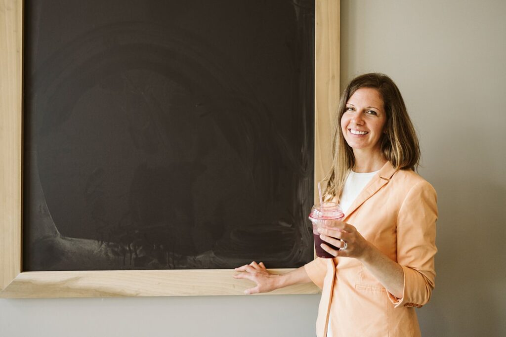 Personal branding portrait of a health coach drinking fresh juice at Salud