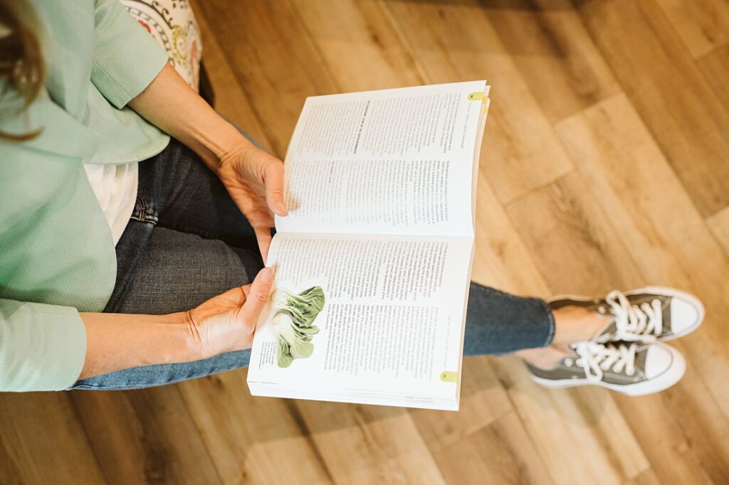 Personal branding portrait of a health coach reading a book in a tea house