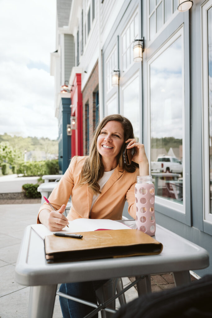 personal branding portrait of a health coach working outside on a phone call
