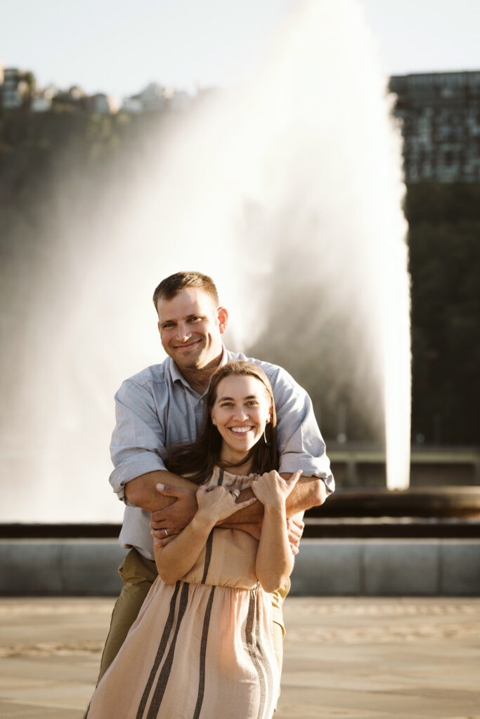 portrait of couple standing near the fountain in Pittsburgh's Point State Park