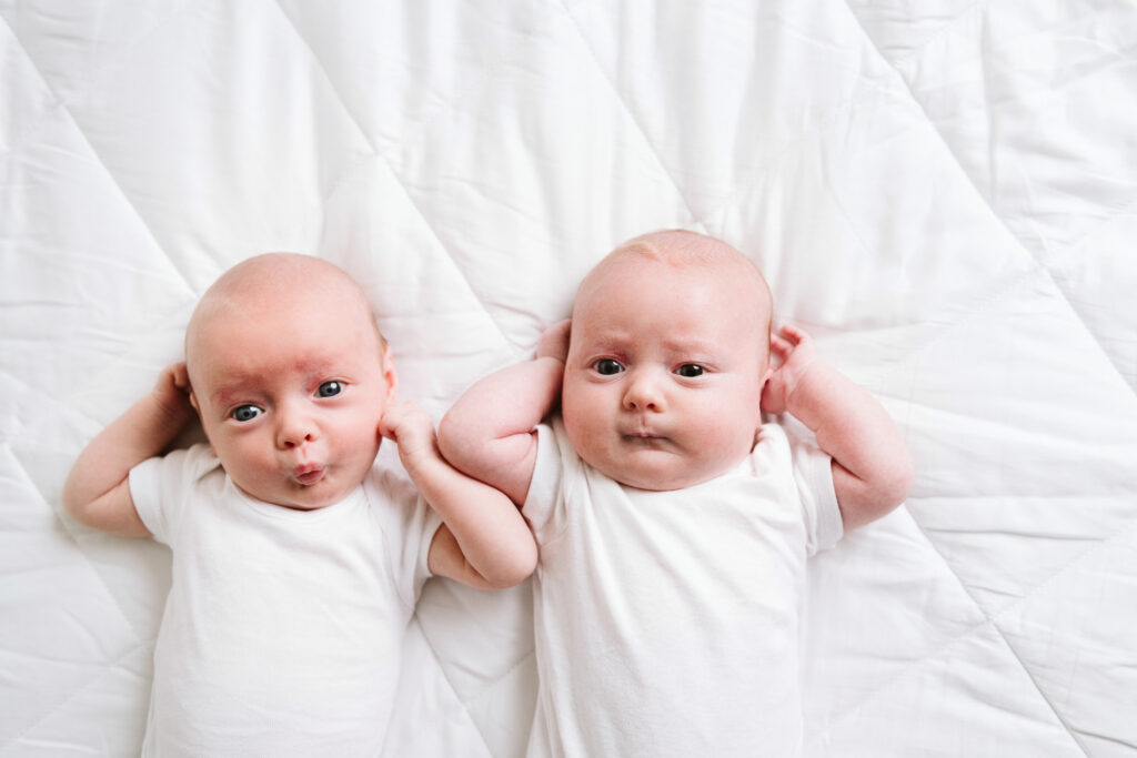 natural newborn twins portrait in modern white studio
