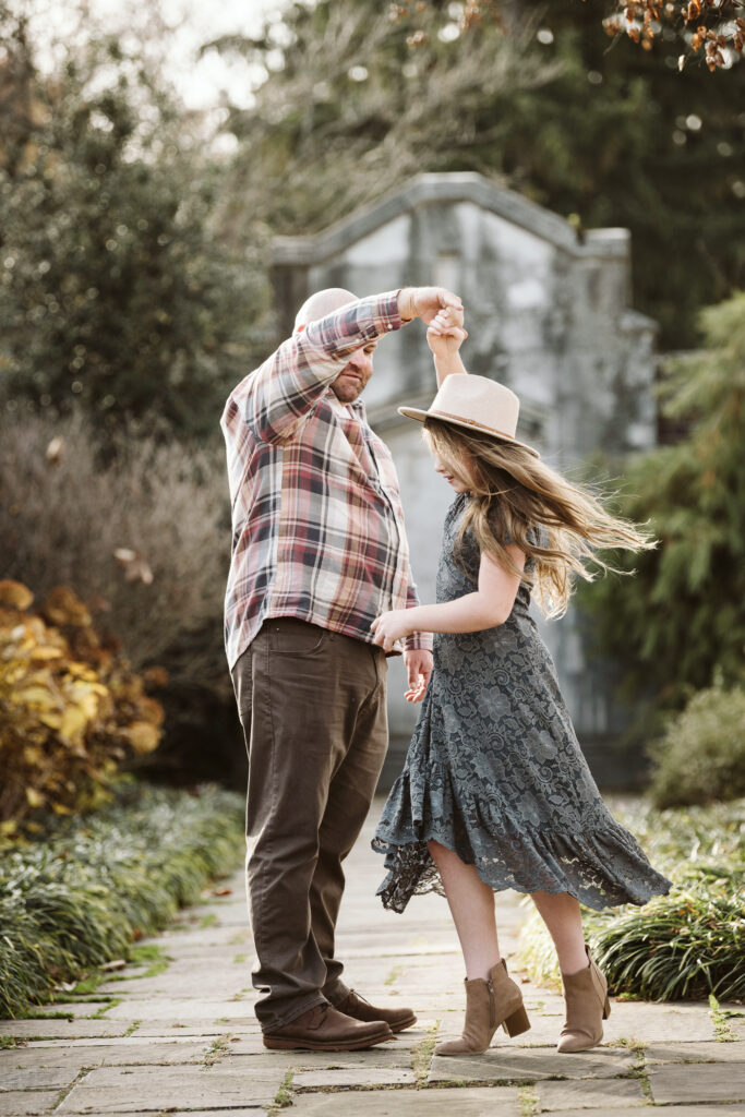 Father and daughter dancing during a photo session in Pittsburgh's Mellon Park