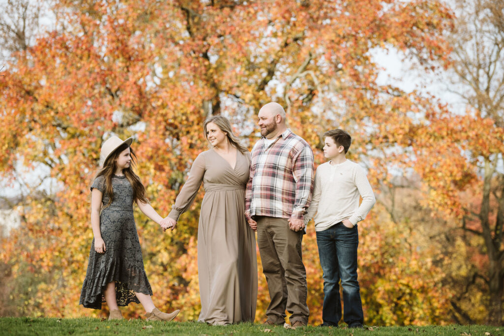 family gathered in the fall during a portrait session in Pittsburgh's Mellon Park