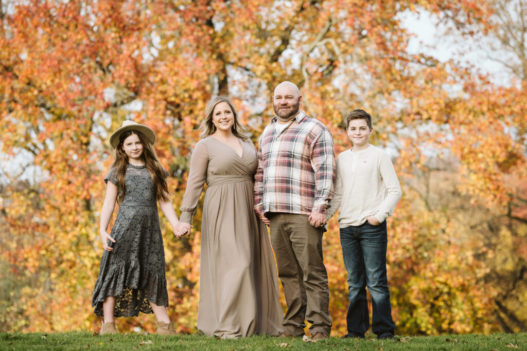 family gathered in the fall during a portrait session in Pittsburgh's Mellon Park