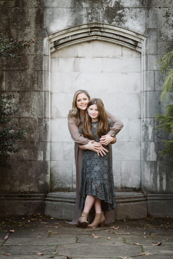 Mother and daughter hugging for a portrait in Pittsburgh's Mellon Park