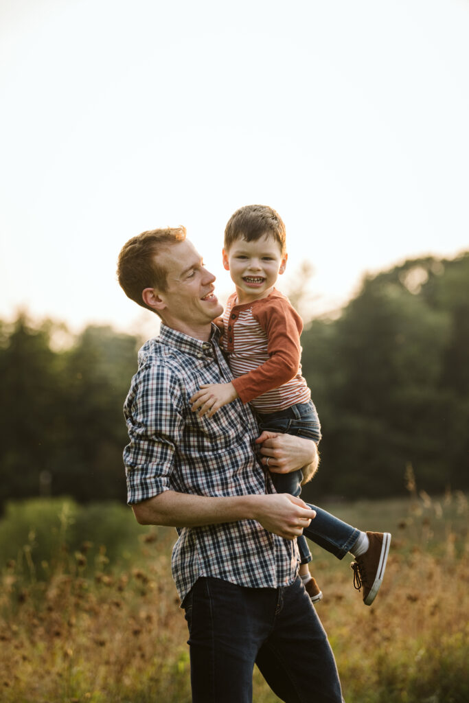 portrait of father and son in a rural field at sunset near Pittsburgh, PA