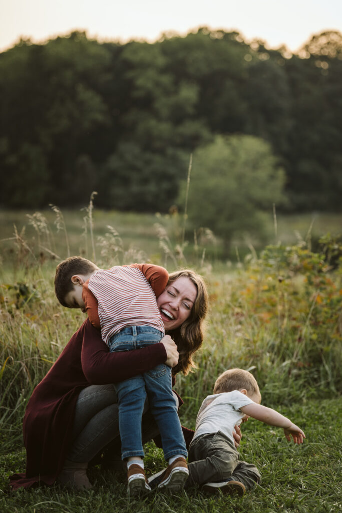 portrait of mother and sons in a rural field at sunset near Pittsburgh, PA