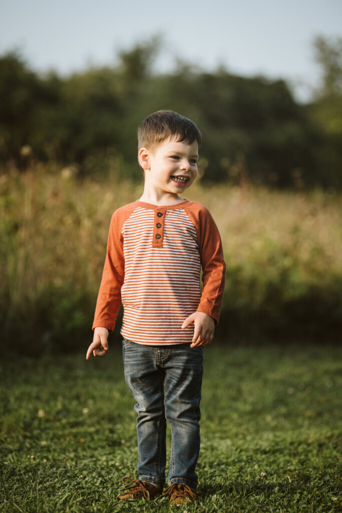 portrait of a boy in a rural field at sunset near Pittsburgh, PA