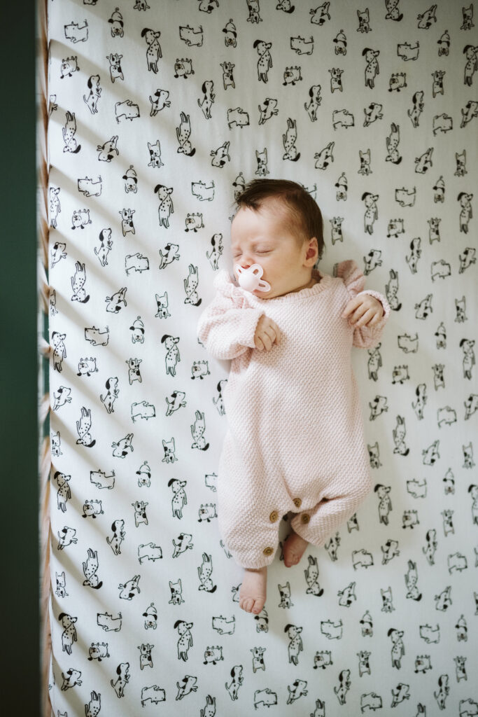 newborn baby sleeping in crib