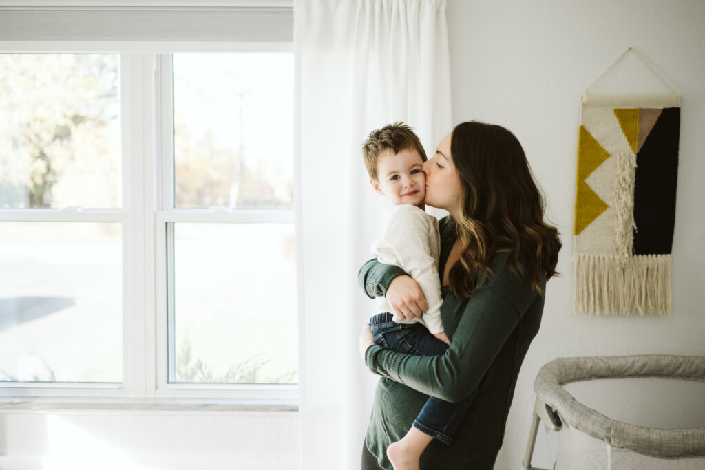 Pittsburgh mom holding boy near window