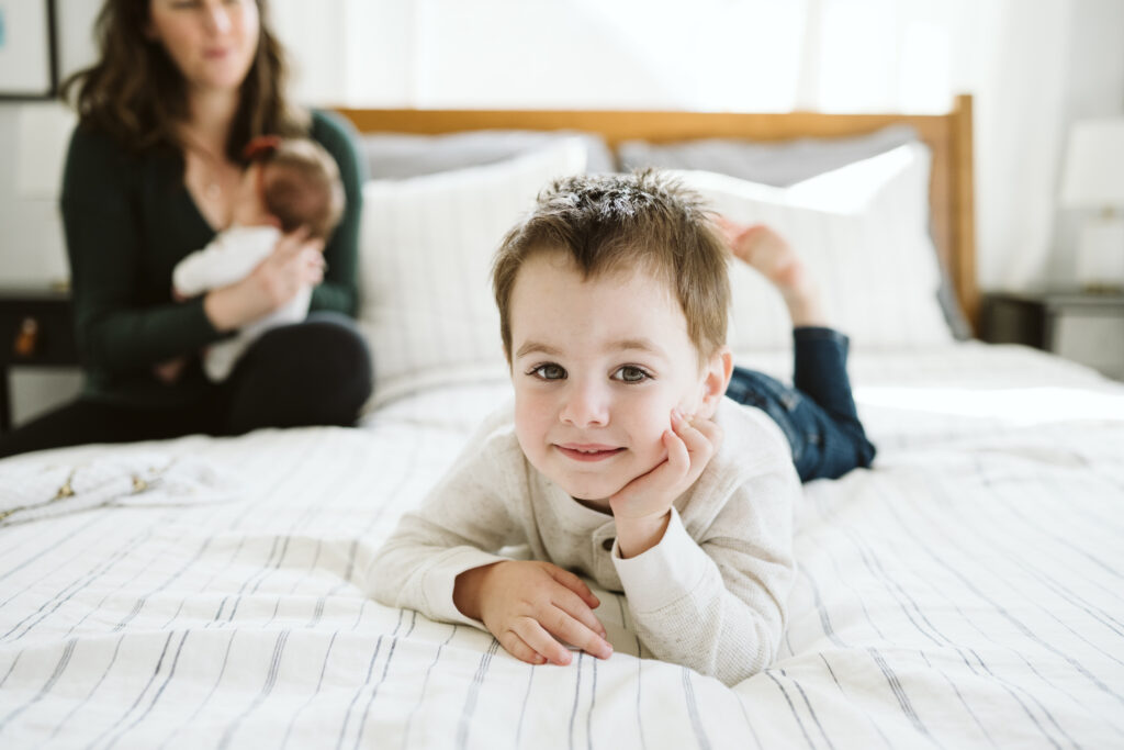 Pittsburgh family sitting in bedroom focusing on son