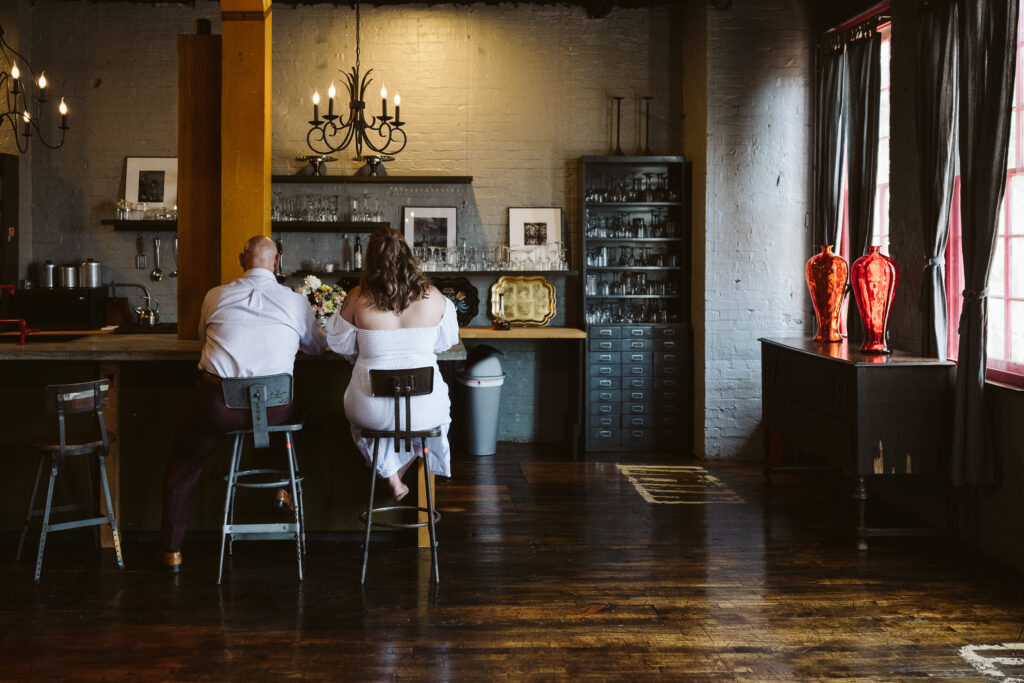 wedding couple enjoying wedding cake in a vintage inspired AirBnB