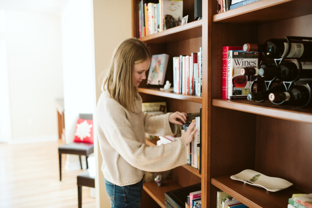 a teenager finding a book in home library