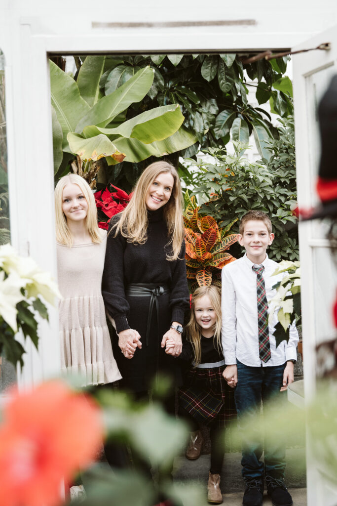 portrait of mom with children in greenhouse