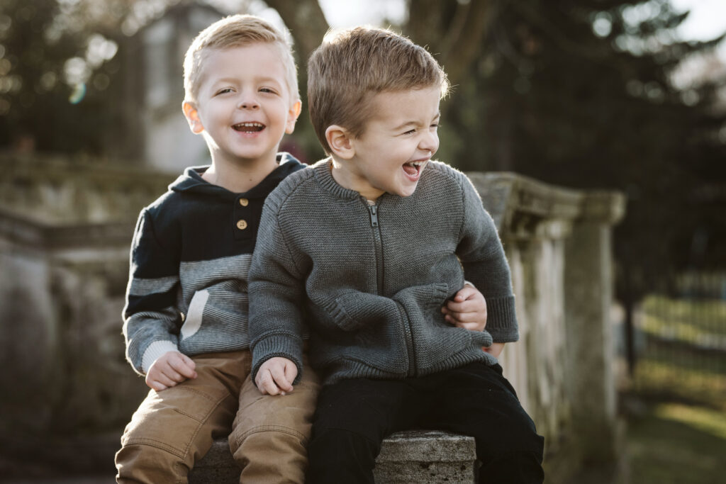 brothers laughing during portrait session in Mellon Park