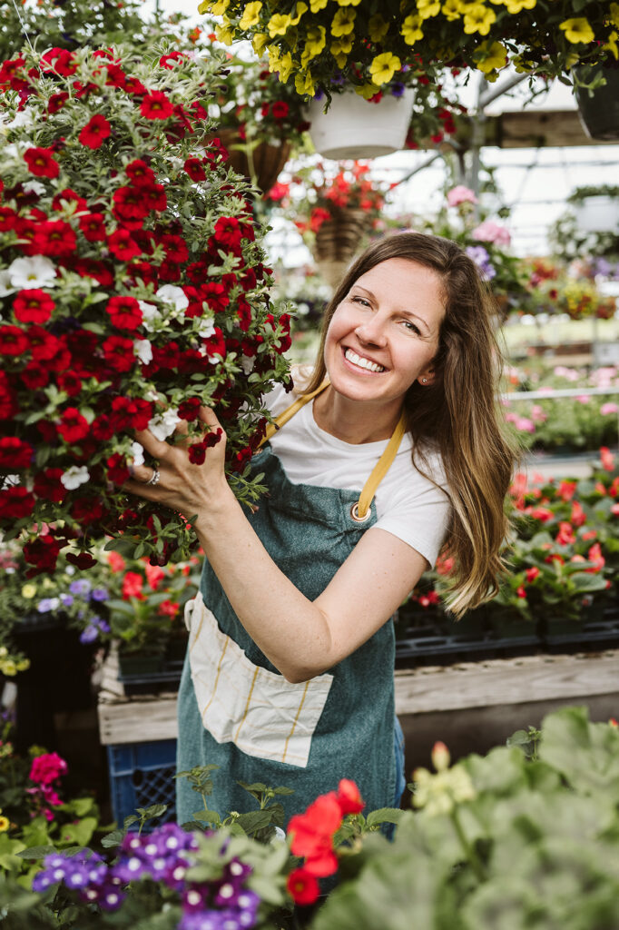 branding portrait of health coach, Green Balanced Gal, standing among flowers