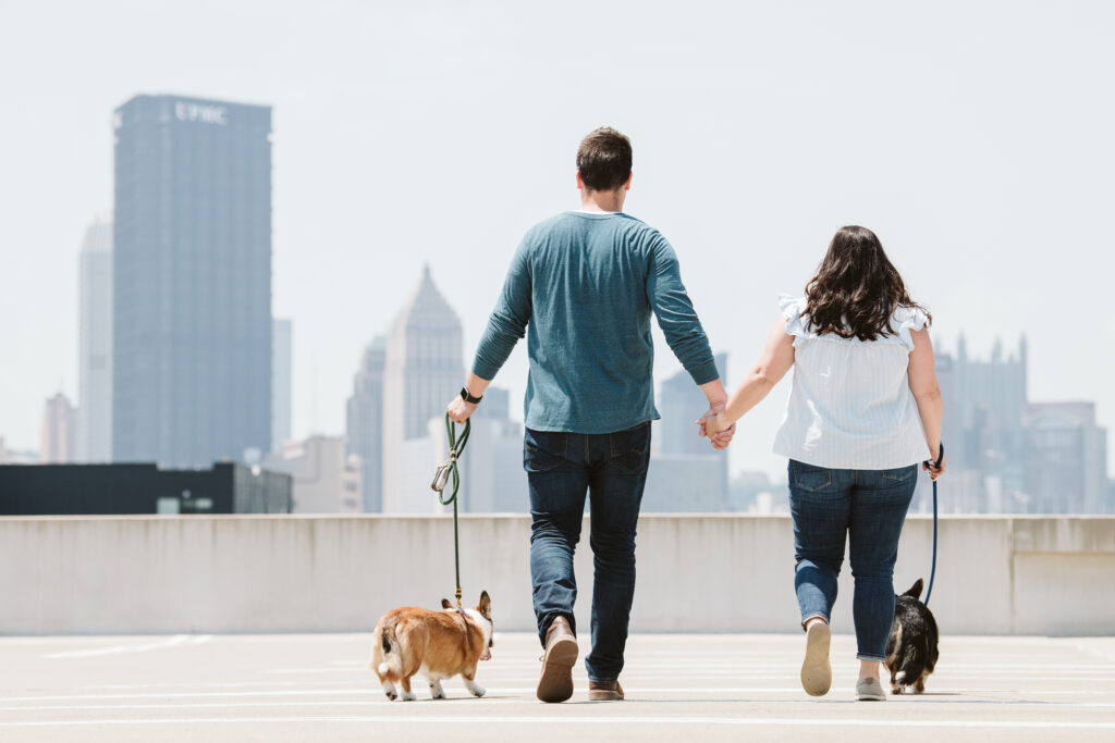 couple walking dogs on parking garage roof in Pittsburgh