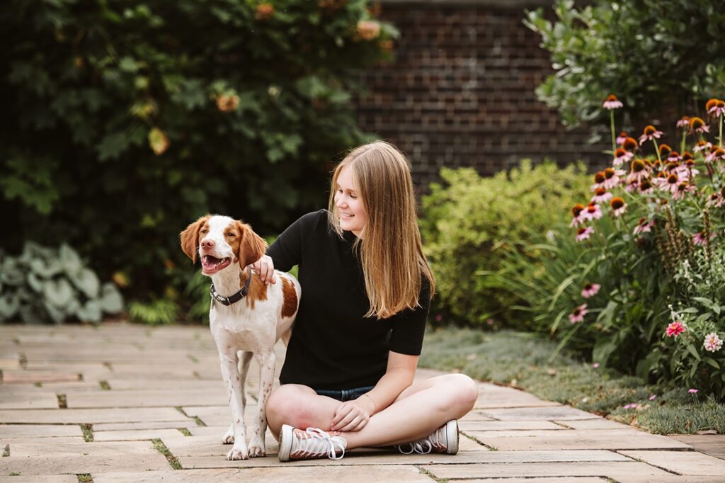 high school senior portrait of girl sitting with dog in Pittsburgh, Mellon Park