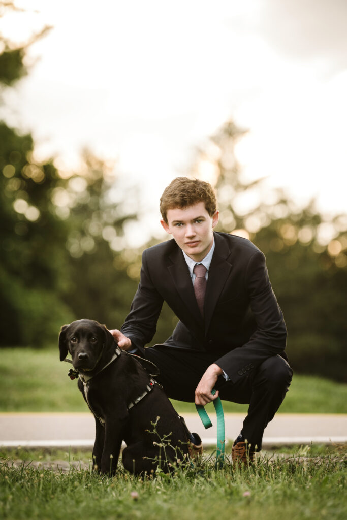 high school senior portrait of guy with dog in Pittsburgh