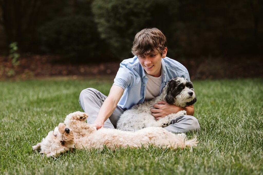 high school senior portrait of guy with dog in Pittsburgh
