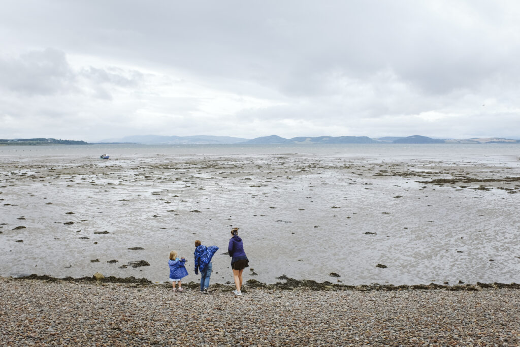 kids skipping rocks on Scottish coast
