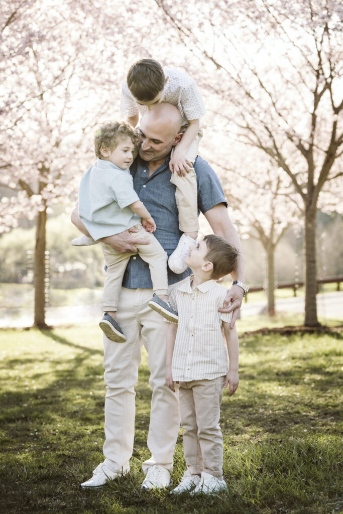 dad with three boys in cherry blossoms