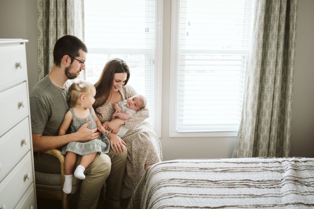 family holding children during newborn lifestyle session