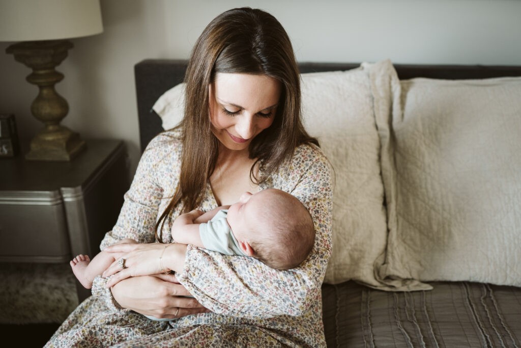 mother holding baby during newborn lifestyle session