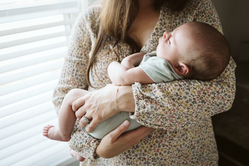 mother holding baby during newborn lifestyle session