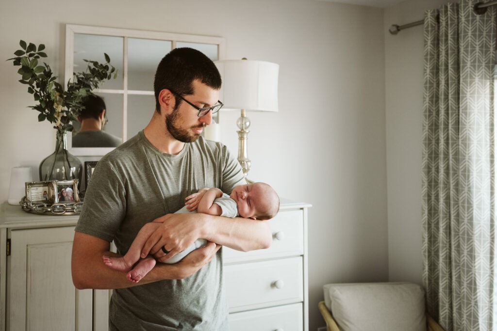 mother holding baby during newborn lifestyle session