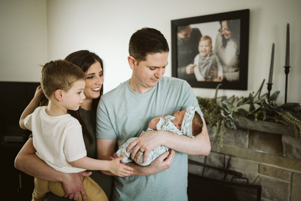 newborn portrait with family standing in their living room