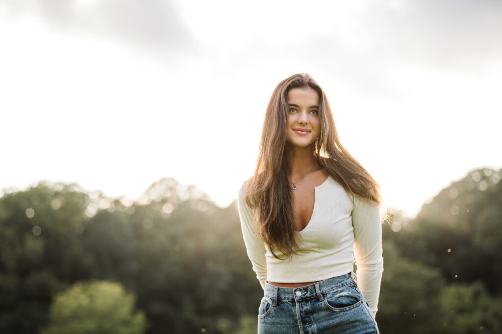 Senior portrait captured in rolling hills at sunset near Pittsburgh, PA