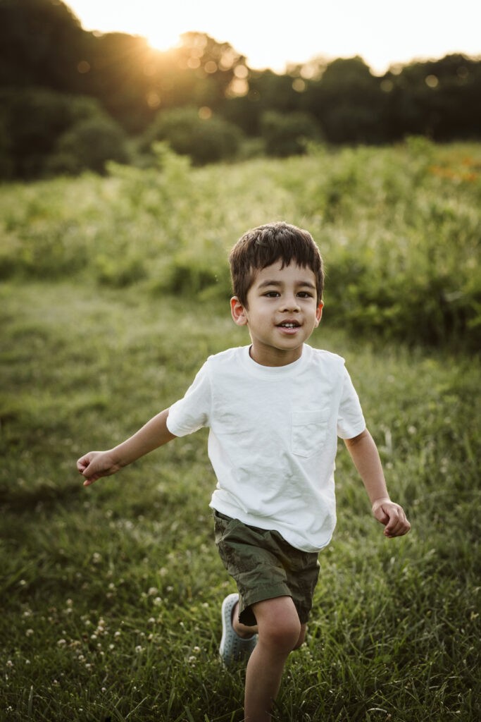 young child running during a portrait in a rural field near Pittsburgh, PA