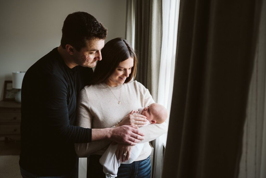 parents holding newborn baby during photo session