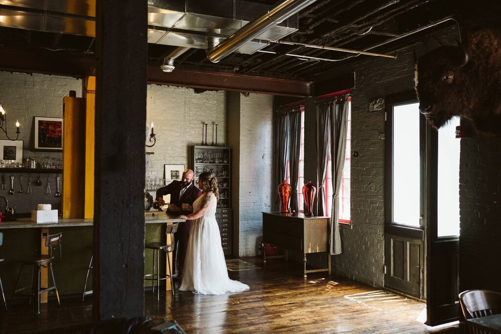 wedding couple sharing a drink before they elope