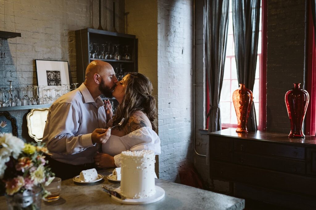 wedding couple sharing cake after they elope