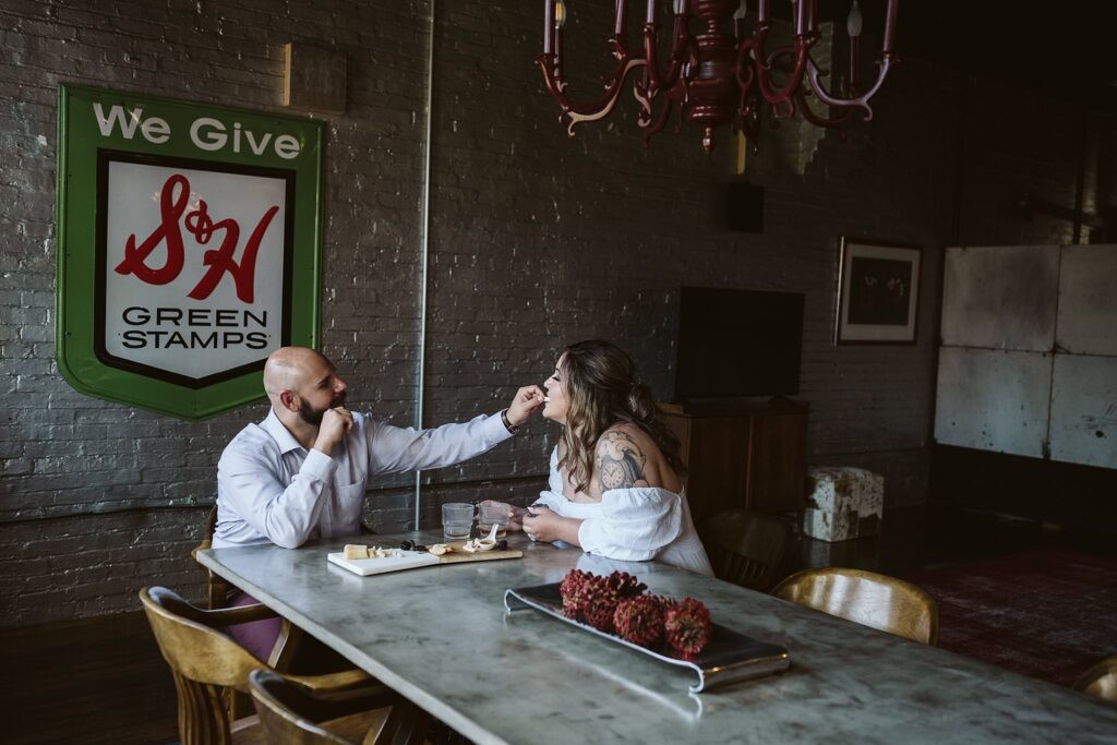 wedding couple enjoying a charcuterie board after they elope