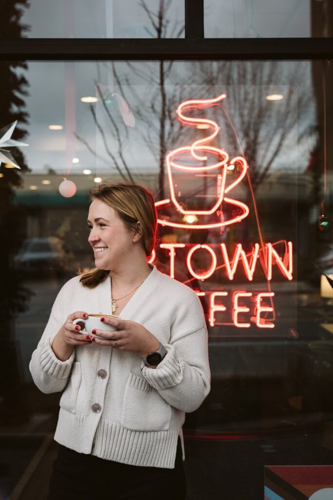 branding portrait of coffee shop owner holding a coffee mug