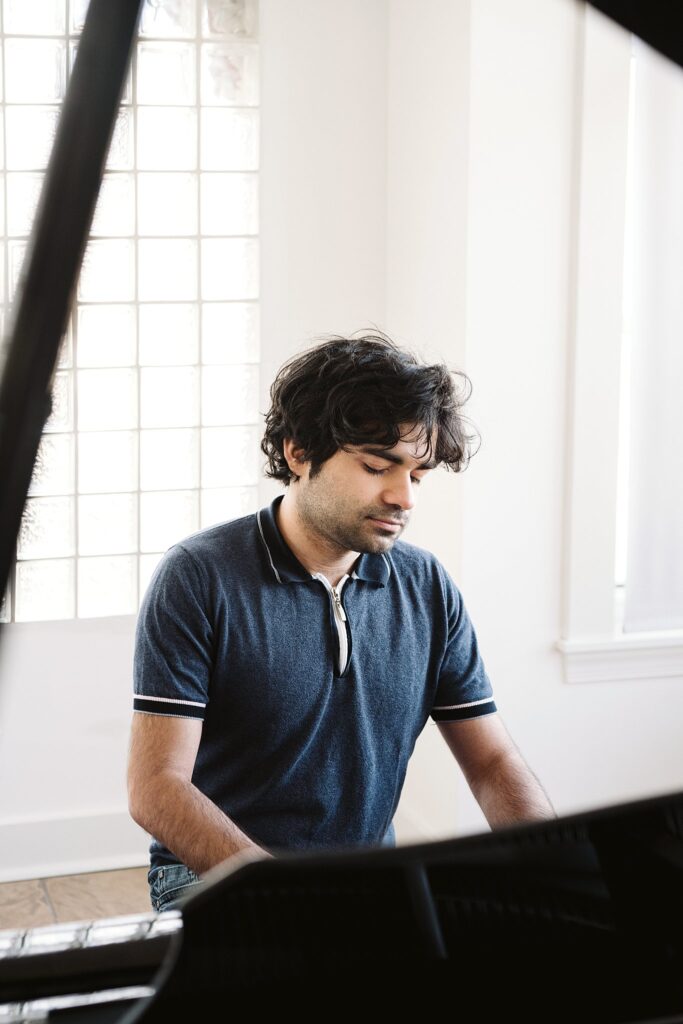 editorial portrait of man playing a grand piano