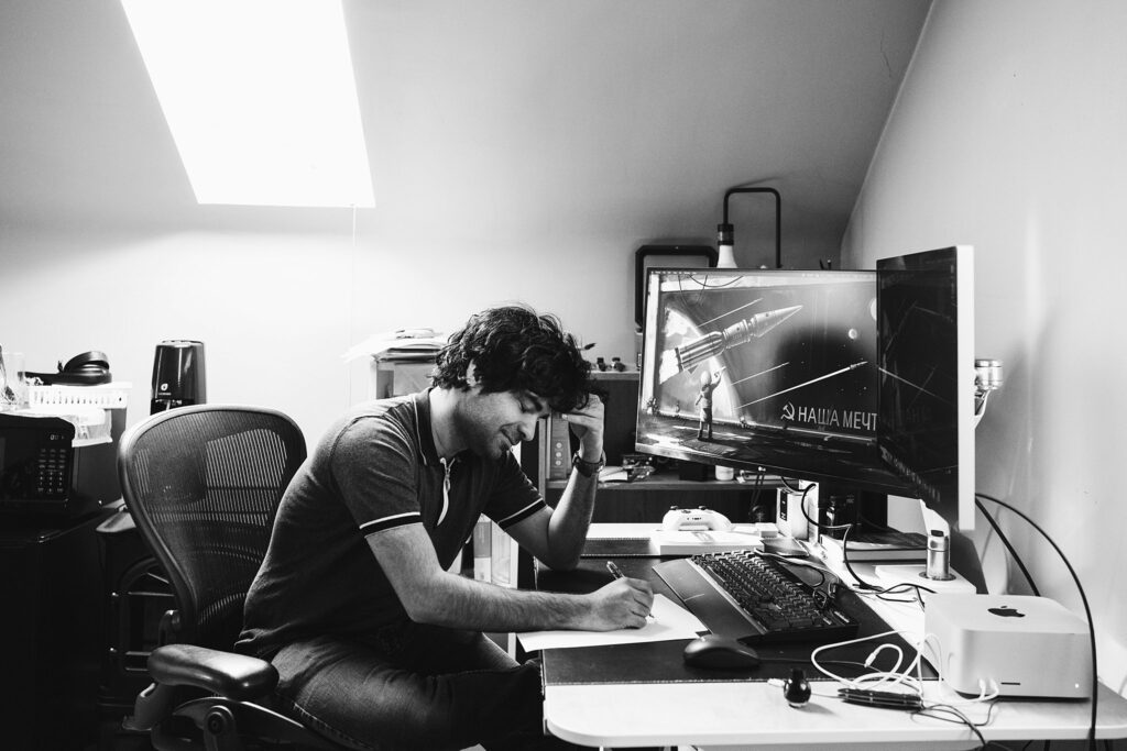 editorial portrait of man working at computer