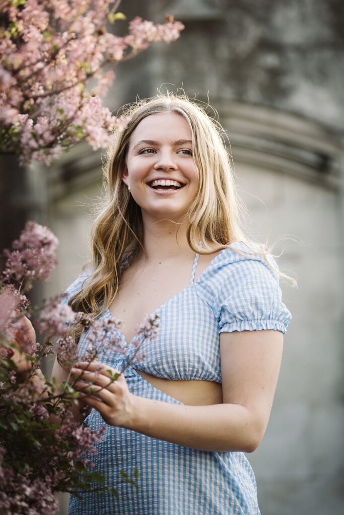 senior girl picture with colorful flowers at sunset