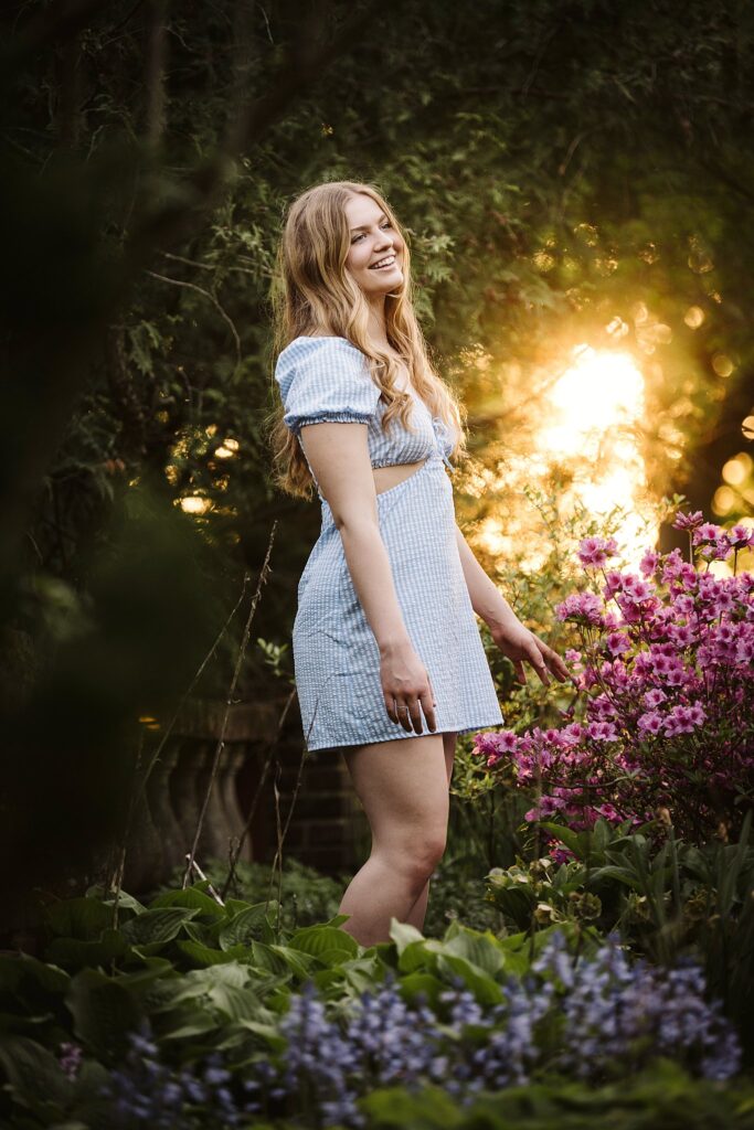 senior girl picture in colorful garden at sunset