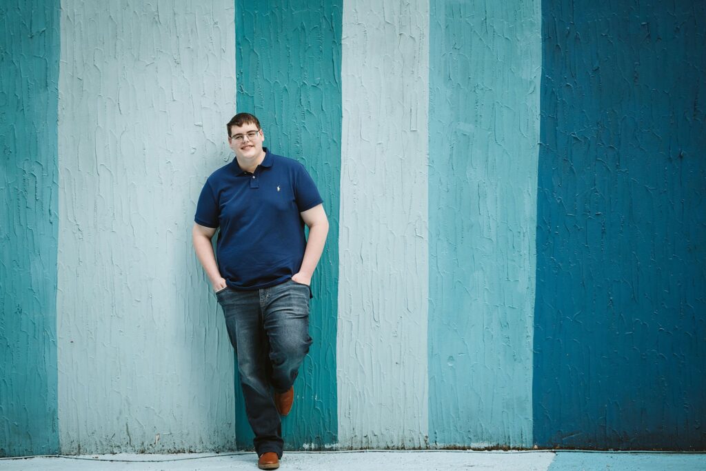 Senior guy photo with blue mural