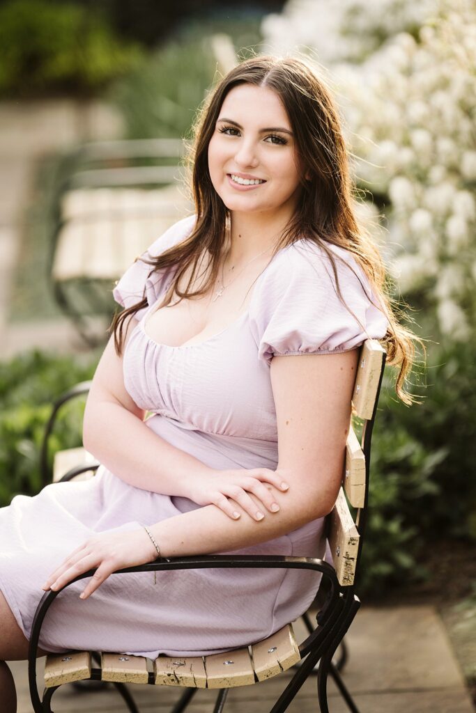 portrait of senior in flower garden at sunset