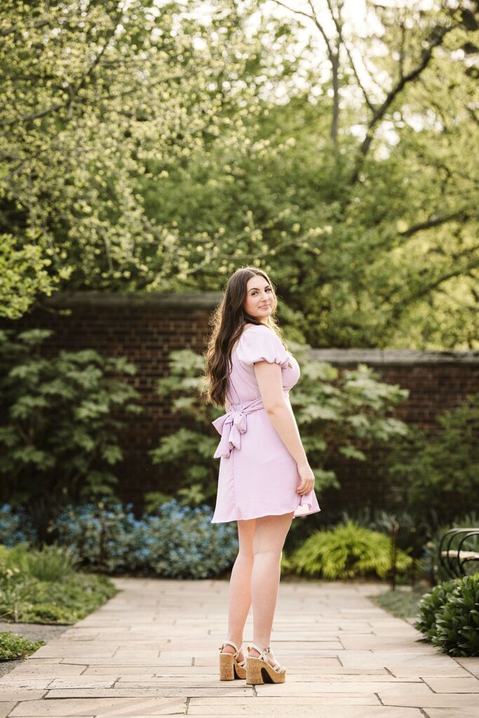 portrait of senior in flower garden at sunset