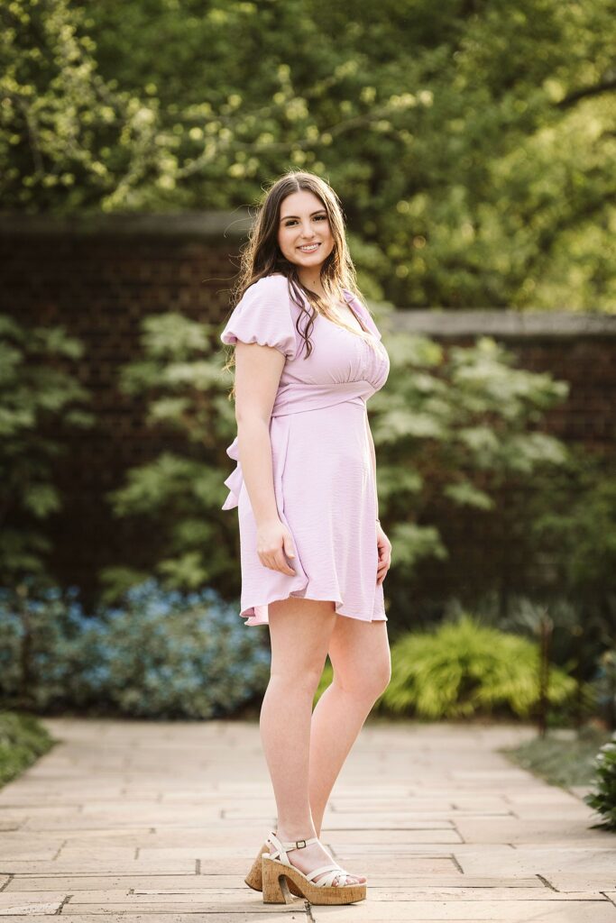 portrait of senior in flower garden at sunset